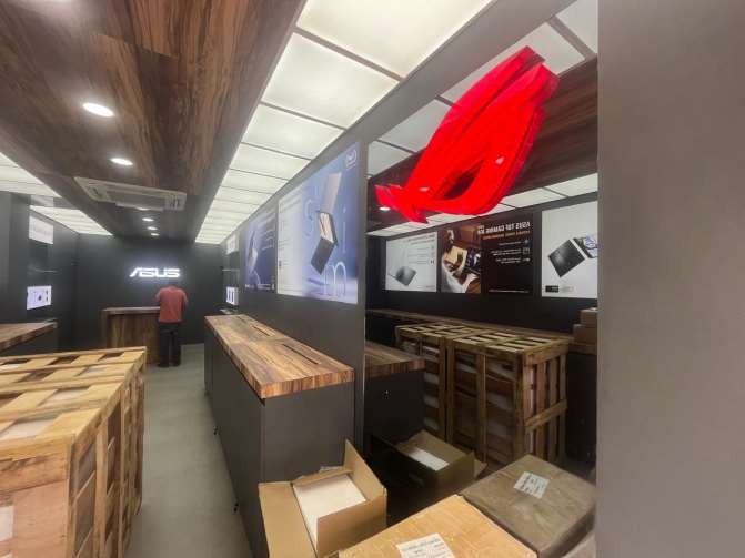 Asus brand store interior fit-out with backlit panels and wooden ceiling