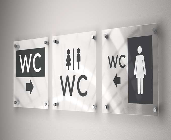 Clear acrylic wayfinding signage panels mounted with chrome standoffs